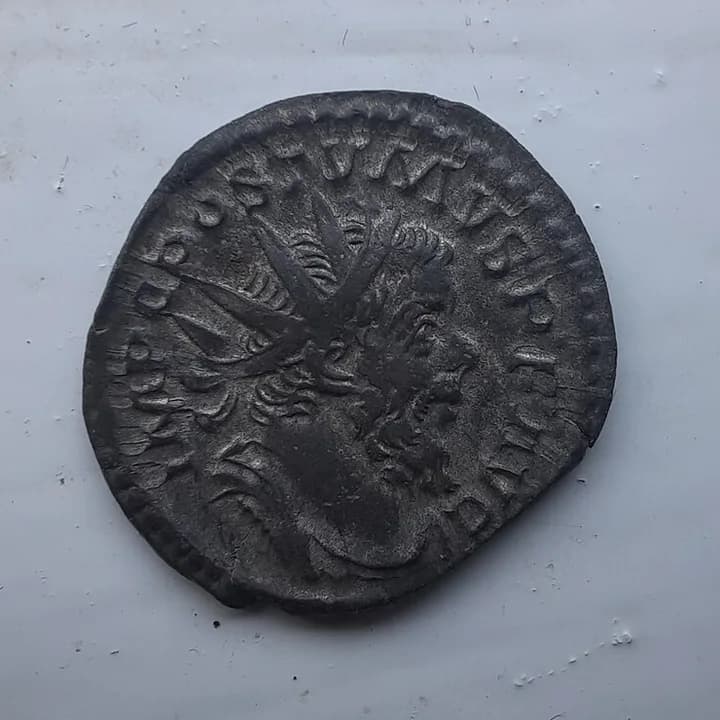 Roman antoninianus showing Postumus wearing a crown with long sun rays